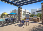 Thumbnail 26 of 33 - our apartments have a large patio with tables and chairs and a pool at Olive Queen Creek Apartments, Queen Creek