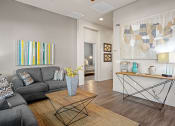 Thumbnail 6 of 36 - a living room with a gray couch and a coffee table at Bella Grace, Chandler, AZ