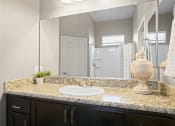 Thumbnail 14 of 36 - a bathroom with a sink and a mirror and a shower at Bella Grace, Chandler