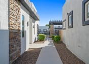 Thumbnail 22 of 36 - a walkway between two buildings with a blue sky in the background at Bella Grace, Chandler, 85225