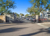 Thumbnail 35 of 36 - the entrance to a parking lot with a gate at Bella Grace, Chandler, Arizona