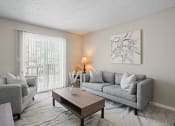 Thumbnail 9 of 24 - a living room with couches and a coffee table