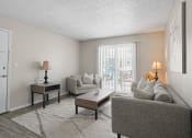 Thumbnail 10 of 24 - a living room with a couch and a table and a sliding glass door