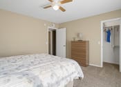 Thumbnail 16 of 29 - bedroom with white blanket on bed, ceiling fan and closet