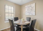 Thumbnail 8 of 29 - dining room area with brown table and brown chairs and large window