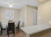 Thumbnail 6 of 29 - dining room area with brown table and brown chairs and view of breakfast bar