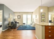 Thumbnail 20 of 49 - a living room with a couch and a table at Skye at Arbor Lakes, Maple Grove, MN