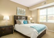 Thumbnail 23 of 49 - a bedroom with a bed and two night stands at Skye at Arbor Lakes, Maple Grove, 55369