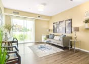 Thumbnail 6 of 49 - a living room with yellow walls and a sliding glass door at Skye at Arbor Lakes, Minnesota, 55369