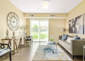 Thumbnail 7 of 49 - a living room with beige walls and a large clock on the wall at Skye at Arbor Lakes, Maple Grove, 55369