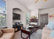 Thumbnail 7 of 34 - a living room with a couch and a coffee table and a television at The Millennium Towne Center Apartments, Baton Rouge