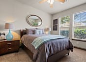 Thumbnail 10 of 34 - a bedroom with a large bed and two windows at The Millennium Towne Center Apartments, Louisiana 70806