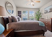 Thumbnail 9 of 34 - Bedroom with cozy bed at The Millennium Towne Center Apartments, Baton Rouge, Louisiana