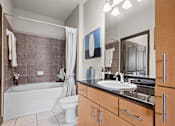Thumbnail 13 of 34 - a bathroom with a sink and a toilet and a tub at The Millennium Towne Center Apartments, Louisiana 70806
