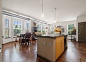 Thumbnail 5 of 34 - a kitchen with a large island in the middle of a living room at The Millennium Towne Center Apartments, Baton Rouge, 70806