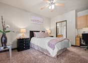Thumbnail 15 of 34 - a bedroom with a bed and a ceiling fan at The Millennium Towne Center Apartments, Louisiana