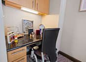 Thumbnail 8 of 34 - a desk with a chair in a small room with a counter top at The Millennium Towne Center Apartments, Baton Rouge, LA, 70806