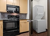 Thumbnail 2 of 34 - a kitchen with a refrigerator and a stove and a microwave at The Millennium Towne Center Apartments, Louisiana