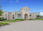 Thumbnail 33 of 34 - the front of a building with a driveway and walkway at The Millennium Towne Center Apartments, Baton Rouge