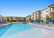 Thumbnail 35 of 48 - our apartments have a large swimming pool with blue lounge chairs
