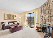 Thumbnail 1 of 40 - a living room with a stone fireplace and a couch at Silver Reef Apartments, Colorado, 80228