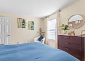Thumbnail 10 of 40 - a bedroom with a bed and a dresser and a window at Silver Reef Apartments, Lakewood