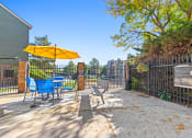 Thumbnail 32 of 40 - our yard has a picnic table with chairs and an umbrella at Silver Reef Apartments, Lakewood, CO, 80228