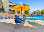 Thumbnail 31 of 40 - our apartments have a pool and a patio with chairs and an umbrella at Silver Reef Apartments, Lakewood