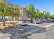 Thumbnail 36 of 40 - a parking lot with cars parked in front of apartment buildings at Silver Reef Apartments, Lakewood, 80228
