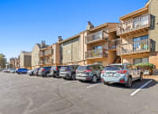Thumbnail 35 of 40 - a row of cars parked in front of an apartment building at Silver Reef Apartments, Lakewood, CO, 80228