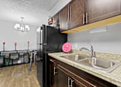 Thumbnail 4 of 35 - a kitchen with a sink and a refrigerator at Park 88 Apartments, Thornton