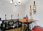 Thumbnail 3 of 35 - a dining area with a table and chairs and a chandelier at Park 88 Apartments, Colorado