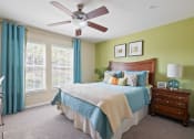Thumbnail 14 of 38 - a bedroom with a large bed and a ceiling fan at 150 Summit, Alabama