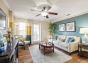Thumbnail 8 of 38 - a living room with a couch and a ceiling fan at 150 Summit, Birmingham, Alabama
