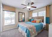 Thumbnail 12 of 38 - a bedroom with a large bed and a ceiling fan at 150 Summit, Birmingham