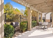 Thumbnail 31 of 38 - a patio with a table and chairs and a grill at 150 Summit, Birmingham, AL, 35243