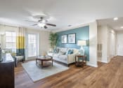 Thumbnail 9 of 38 - a living room with a couch and a ceiling fan at 150 Summit, Birmingham, 35243