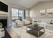 Thumbnail 4 of 23 - a living room with a couch chair coffee table and fireplace