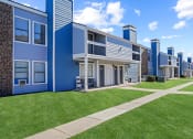 Thumbnail 18 of 24 - blue building and sky and green grass