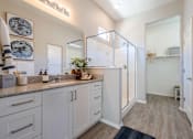 Thumbnail 7 of 15 - A kitchen with white cabinets and a grey countertop. at Vistoria At Marley Park Apartments, Surprise, Arizona