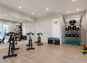 Thumbnail 10 of 16 - A room with exercise equipment and a bench.
