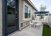 Thumbnail 8 of 15 - A patio with a table and chairs and an umbrella. at Vistoria At Stadium Apartments, Glendale, Arizona