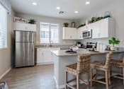 Thumbnail 2 of 15 - A kitchen with a refrigerator, sink, and countertop. at Vistoria At Stadium Apartments, Glendale, 85305