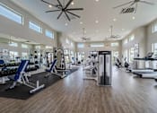 Thumbnail 10 of 15 - A spacious gym with a variety of equipment and a ceiling fan. at Vistoria At Stadium Apartments, Glendale, Arizona