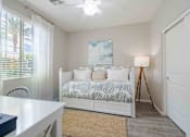 Thumbnail 10 of 15 - A bedroom with a bed, a table, and a painting on the wall. at Vistoria At Country Place Apartments, Arizona, 85353