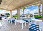 Thumbnail 14 of 15 - A patio with a pool and a striped cushion. at Vistoria At Country Place Apartments, Tolleson, Arizona