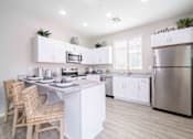 Thumbnail 1 of 15 - A modern kitchen with a center island and stainless steel appliances. at Vistoria At Country Place Apartments, Tolleson, 85353