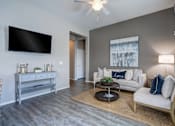 Thumbnail 3 of 3 - Modern living room with gray sofa at Vistoria On Camelback Apartments, Arizona