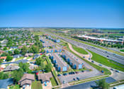 Thumbnail 24 of 24 - aerial view of blue building and sky and green grass