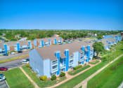 Thumbnail 22 of 24 - aerial view of blue building and sky and green grass